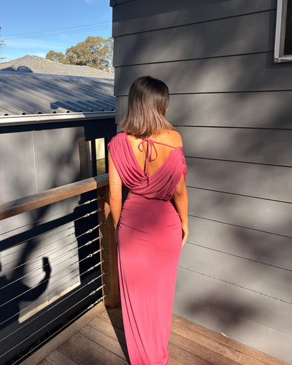 The Benni Celia Set in Rose Wine is a designer two-piece outfit featuring a gathered crop top with a versatile off-the-shoulder neckline and a matching draped maxi skirt. Crafted from soft stretch jersey in a rich rose wine hue, this elegant set is perfect for weddings, engagement parties, formal events, cocktail occasions, and special celebrations.