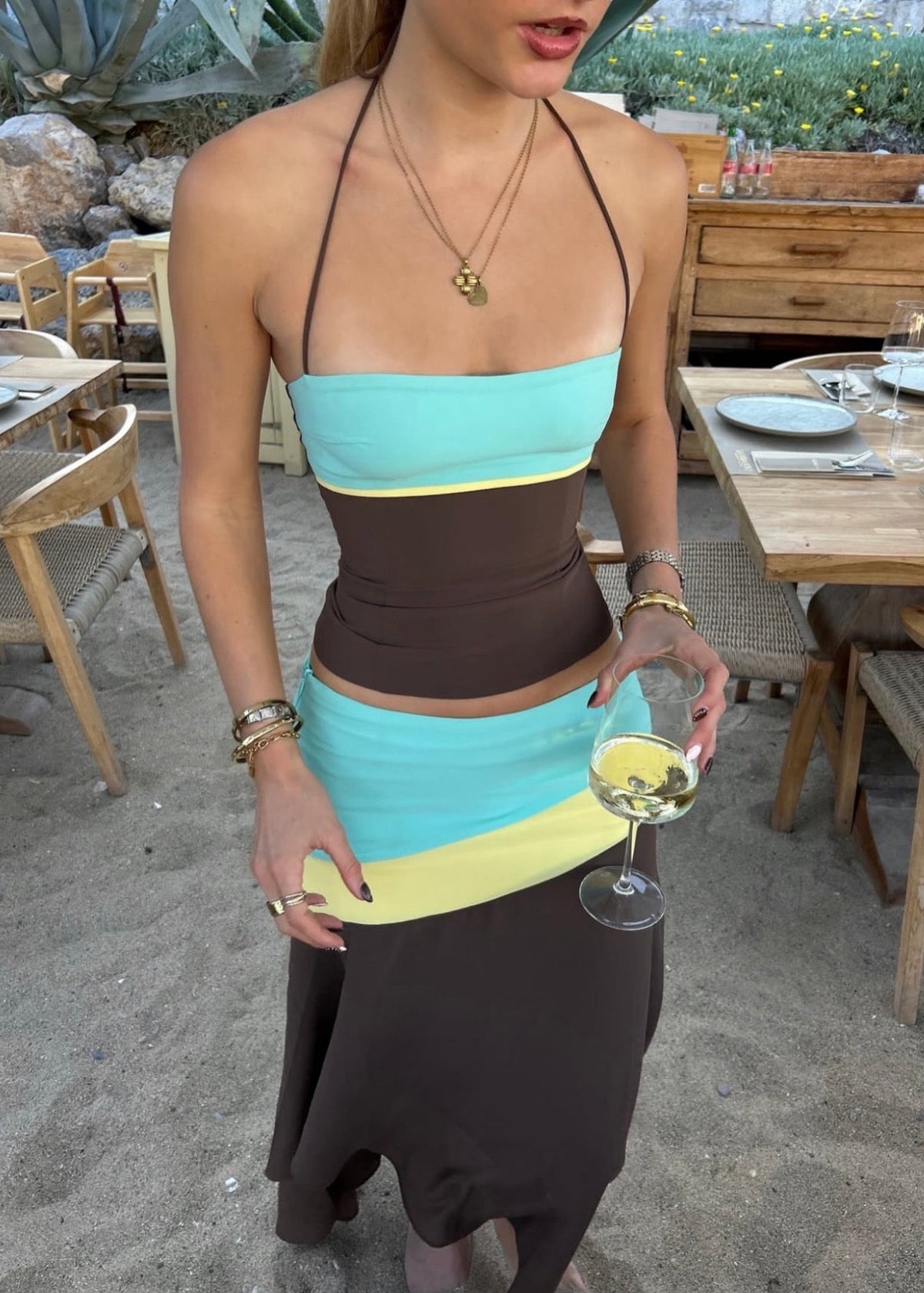 Sleeveless colour-block maxi dress featuring a turquoise bandeau bodice, chocolate brown fitted waist, pale yellow accent panels and an asymmetric flowing skirt. Designed with thin halter straps and a soft draped silhouette, perfect for weddings, races, holiday events and summer occasions.